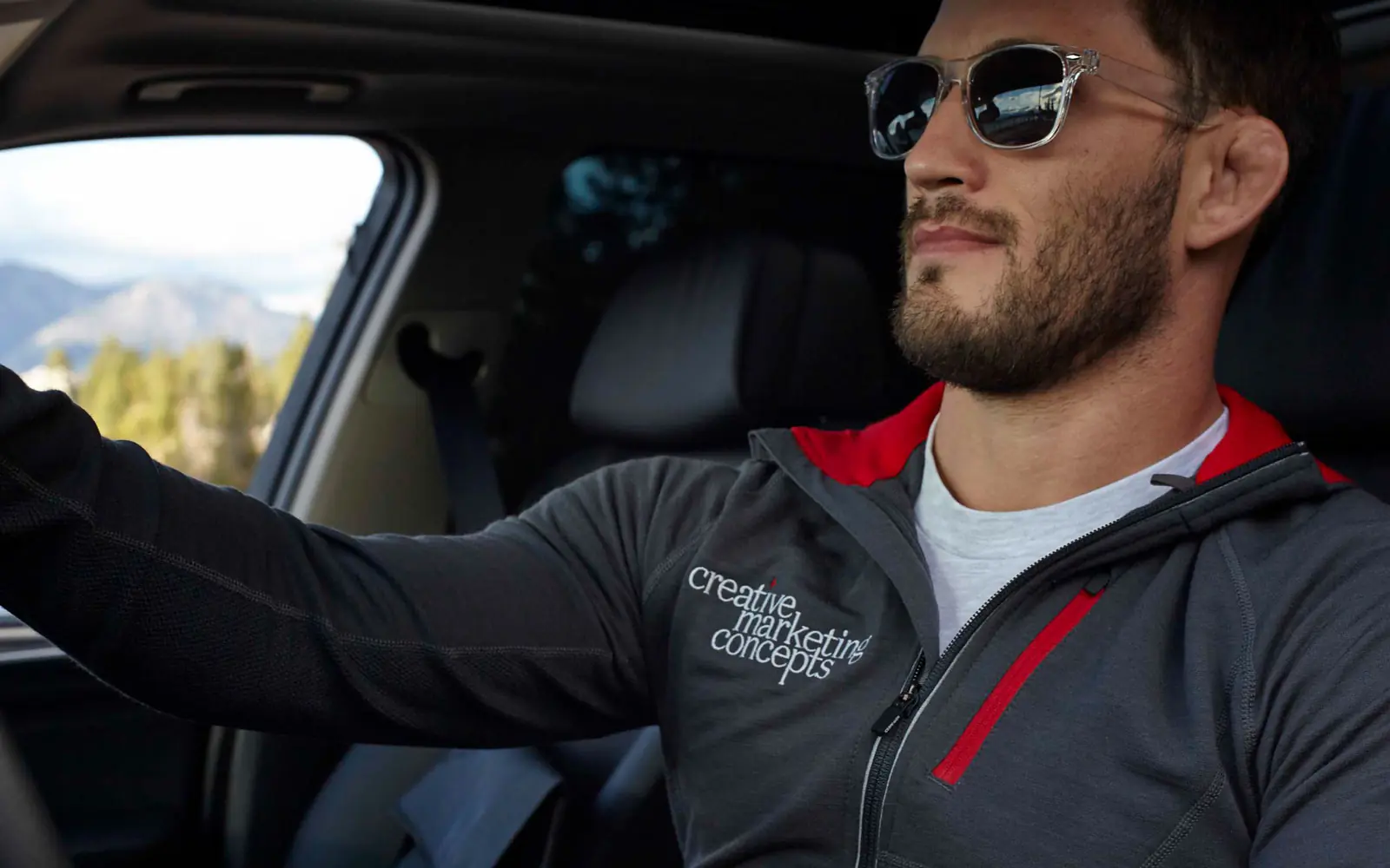 man in sunglasses with branded CMC shirt