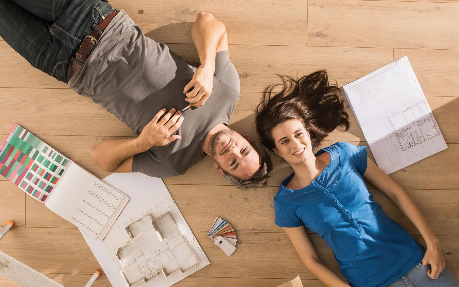 couple daydreaming laying on floor